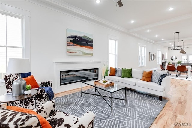 living room with crown molding and hardwood / wood-style flooring