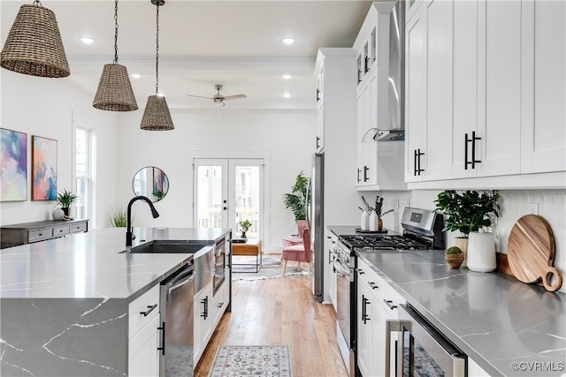 511 N 33rd St, Richmond, VA 23223 - kitchen with stainless steel counters, appliances with stainless steel finishes, wine cooler, a ceiling fan, and light wood-style floors