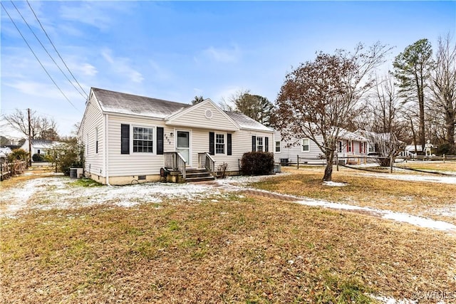 view of front of property with central AC and a front yard