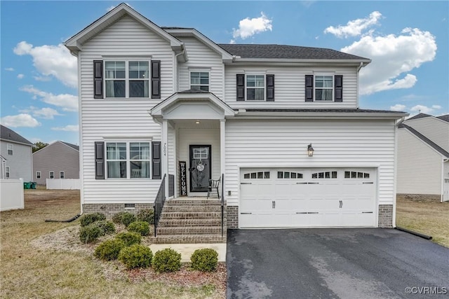 view of front of house featuring a garage and a front lawn