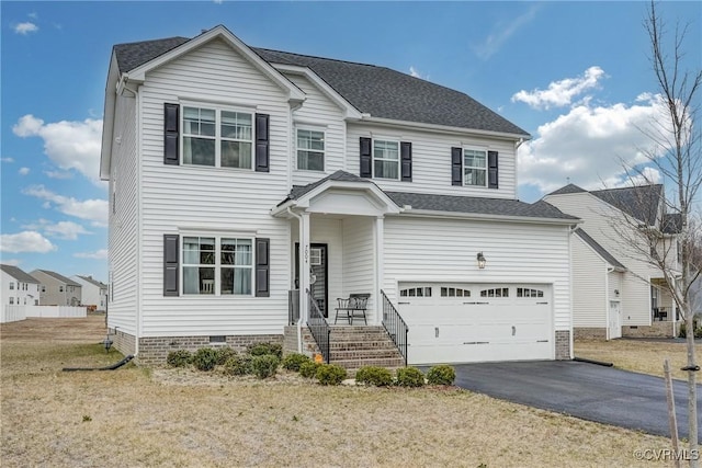 view of front of property with a garage and a front lawn