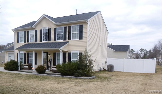 view of front of house with central AC, covered porch, and a front lawn