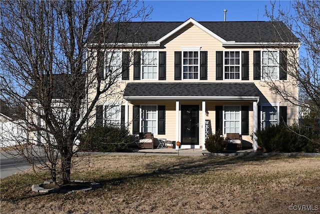 colonial home featuring a front yard