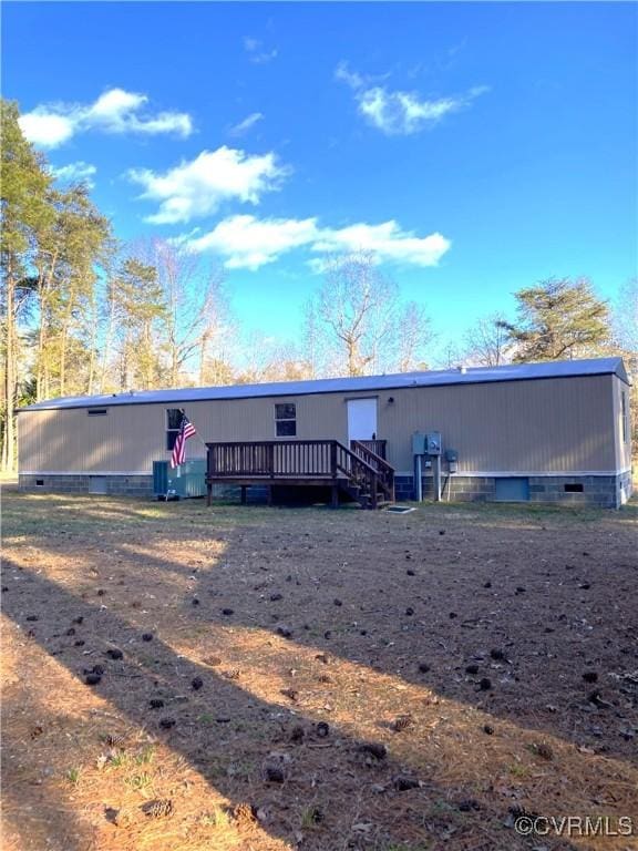 back of property featuring a wooden deck