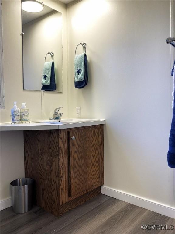 bathroom featuring hardwood / wood-style flooring and vanity