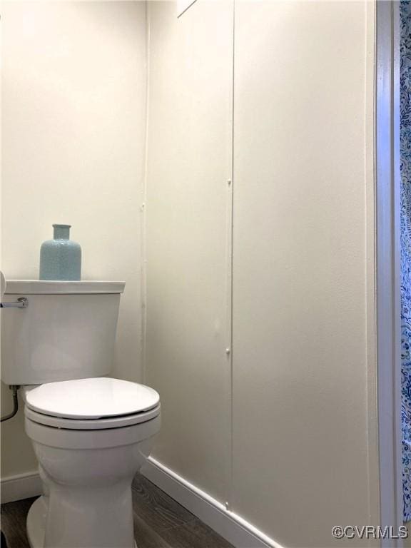 bathroom with toilet and hardwood / wood-style floors