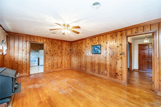 interior space featuring crown molding, wood-type flooring, and ceiling fan