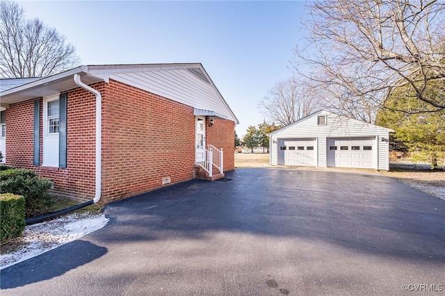 view of home's exterior featuring a garage and an outbuilding