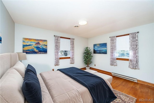 bedroom with hardwood / wood-style flooring and a baseboard radiator