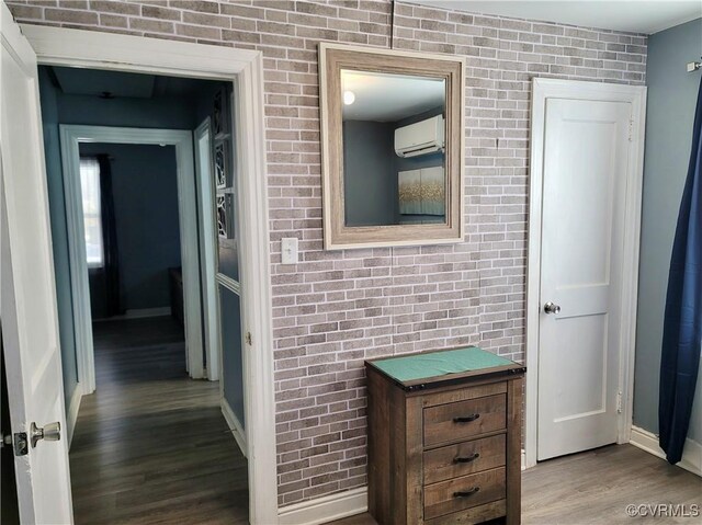 hall featuring a wall mounted AC and light wood-type flooring