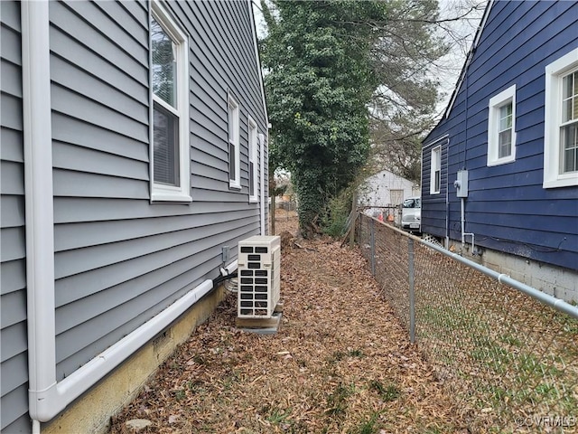 view of side of home with ac unit