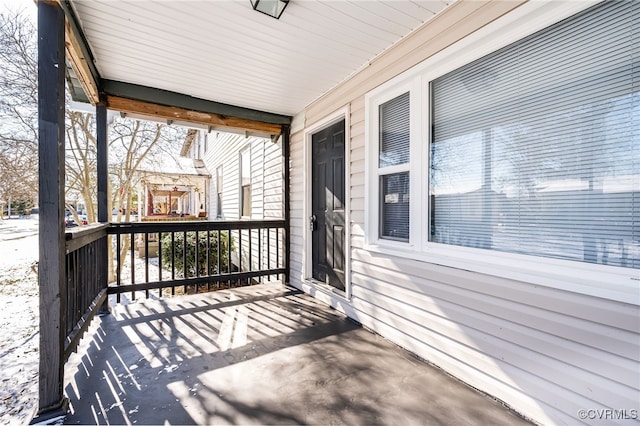 wooden terrace featuring covered porch