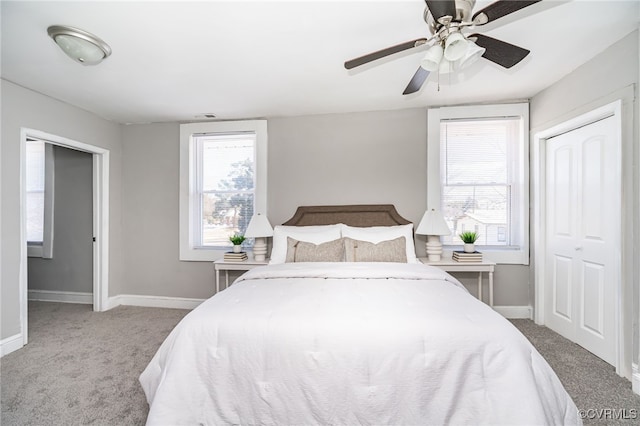 carpeted bedroom with a closet and ceiling fan