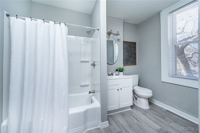 full bathroom with hardwood / wood-style flooring, vanity, toilet, and shower / bath combo with shower curtain