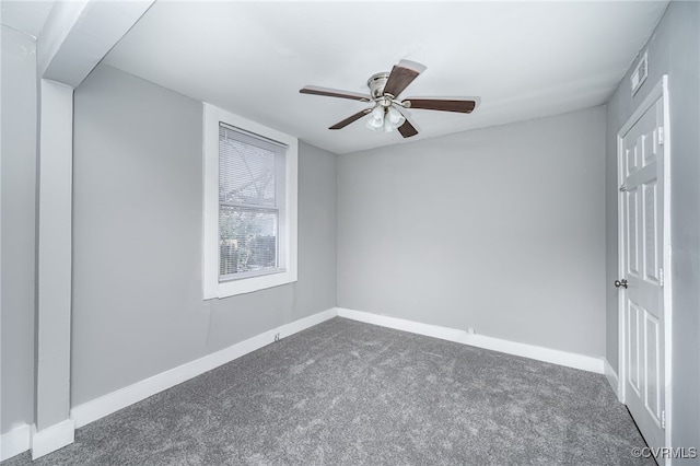 carpeted spare room featuring ceiling fan