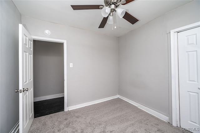 unfurnished bedroom with ceiling fan and carpet floors