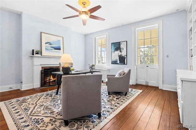 living area with hardwood / wood-style flooring and ceiling fan