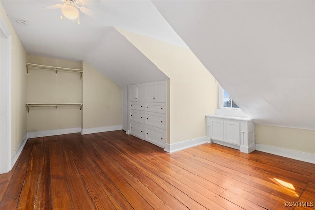 bonus room with wood-type flooring, vaulted ceiling, and ceiling fan