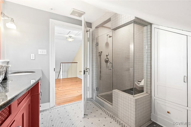 bathroom featuring tile patterned flooring, vanity, and a shower with door