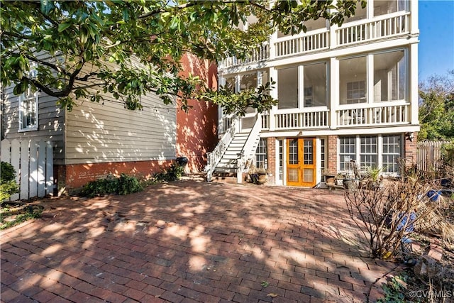 back of house with a balcony and a patio