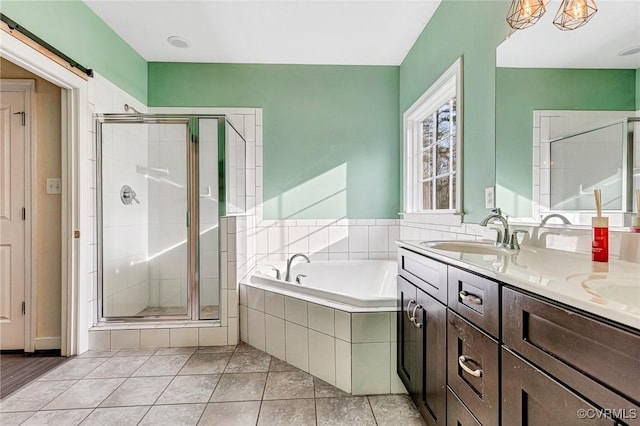 bathroom featuring tile patterned flooring, vanity, and plus walk in shower