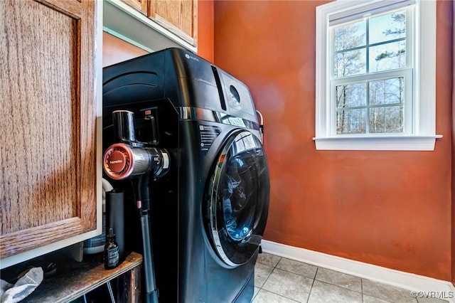 laundry room with a healthy amount of sunlight and light tile patterned floors