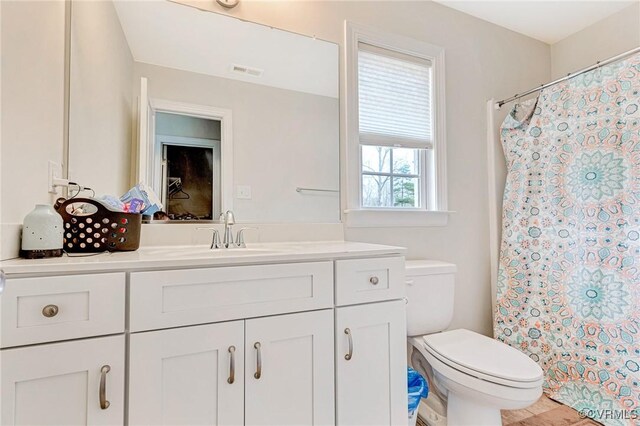 bathroom featuring vanity and toilet