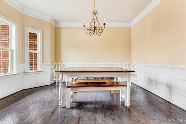 dining area with ornamental molding, dark hardwood / wood-style floors, an inviting chandelier, and breakfast area