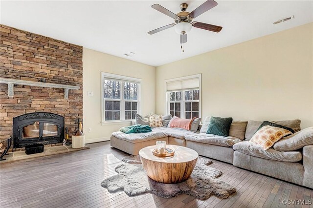 living room with wood-type flooring and ceiling fan