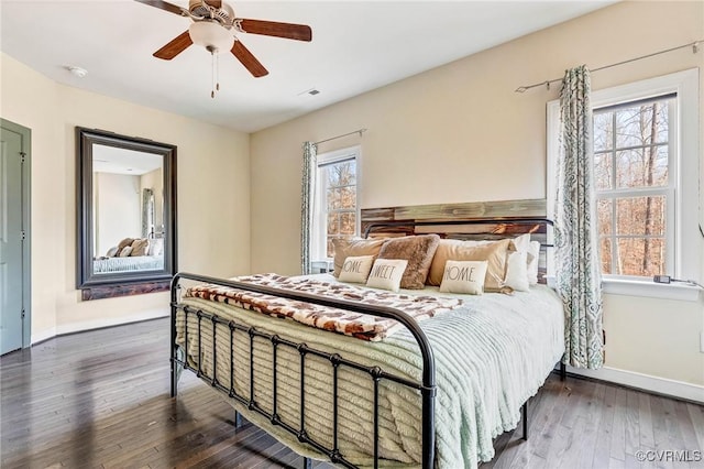 bedroom with dark wood-type flooring and ceiling fan