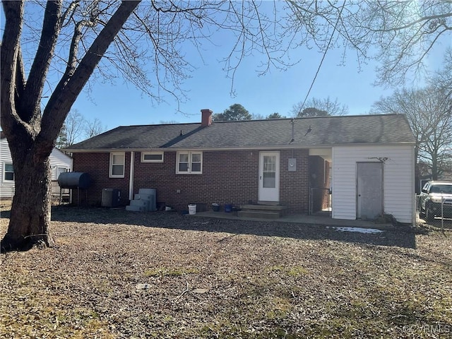 rear view of property with central AC unit