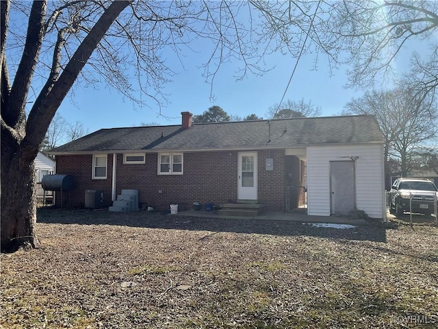 rear view of property with cooling unit