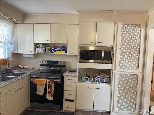 kitchen featuring ornamental molding, appliances with stainless steel finishes, and sink