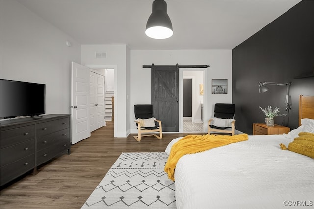 2616 Lassen Walk Unit B, Henrico, VA 23294 - bedroom with baseboards, visible vents, a barn door, and wood finished floors