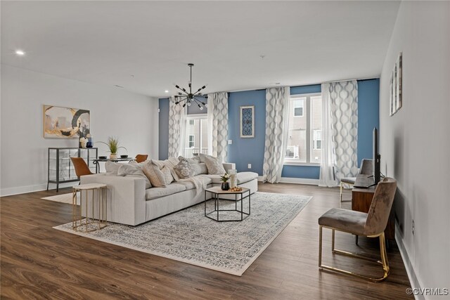 living room with a chandelier and dark hardwood / wood-style flooring