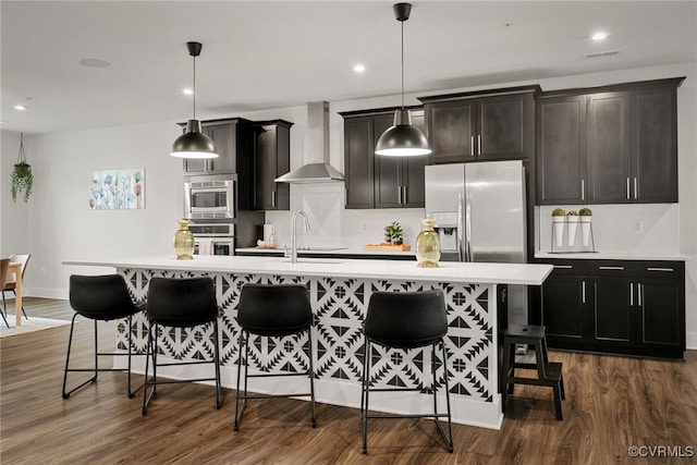 2616 Lassen Walk Unit B, Henrico, VA 23294 - kitchen with stainless steel appliances, tasteful backsplash, a kitchen bar, and wall chimney exhaust hood