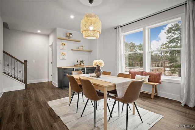 dining room featuring dark wood-type flooring and plenty of natural light