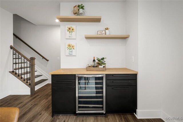 bar with butcher block countertops, wine cooler, and dark hardwood / wood-style flooring