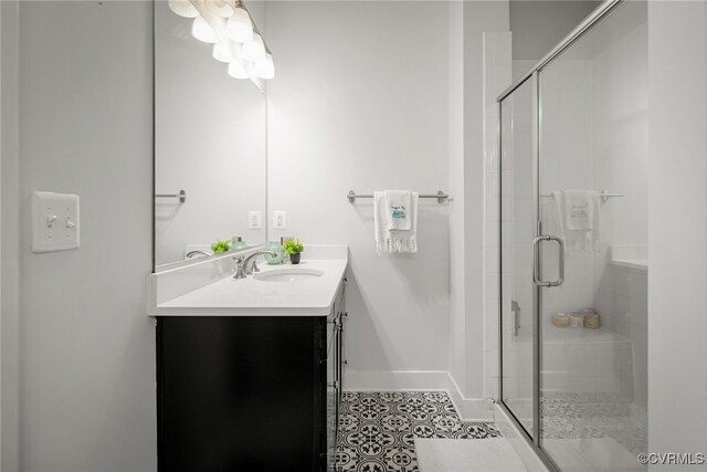 bathroom featuring tile patterned flooring, vanity, and a shower with shower door