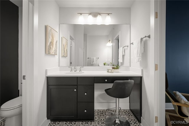 bathroom featuring vanity and toilet