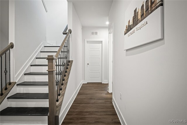 stairs featuring wood-type flooring