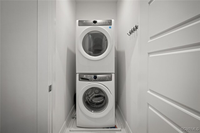 laundry area with stacked washing maching and dryer