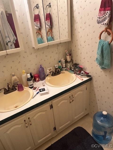 bathroom with vanity and tile patterned flooring