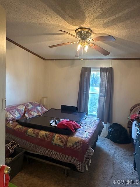 bedroom featuring a textured ceiling, ceiling fan, and carpet