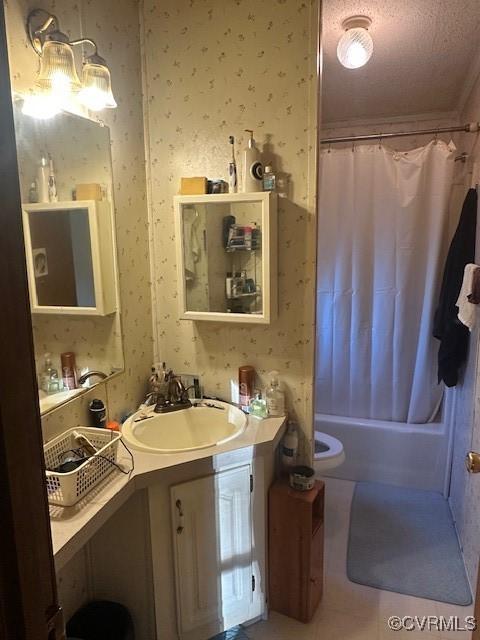 bathroom featuring vanity, tile patterned flooring, a textured ceiling, and shower / bath combo