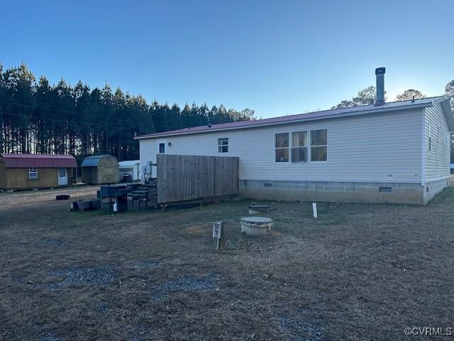 back of property with a storage unit