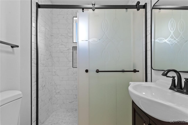 bathroom featuring vanity, an enclosed shower, and toilet