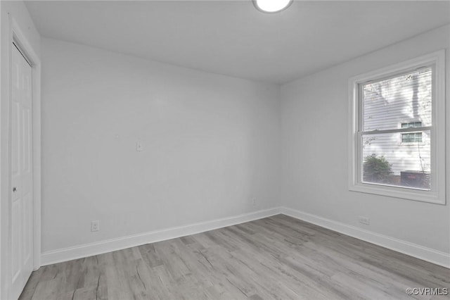 unfurnished room with light hardwood / wood-style flooring and a healthy amount of sunlight