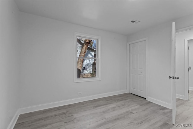 spare room featuring light wood-type flooring