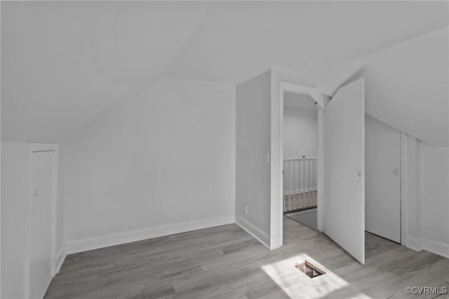 bonus room featuring vaulted ceiling and light hardwood / wood-style flooring